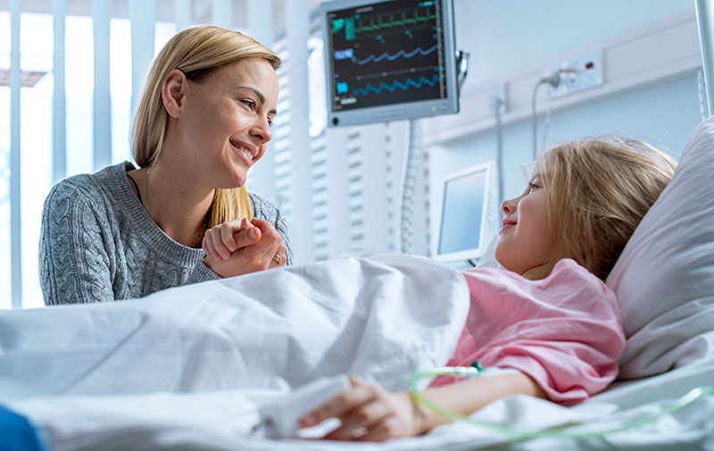 mother-and-child-in-hospital Mother at bedside of sick child in hospital